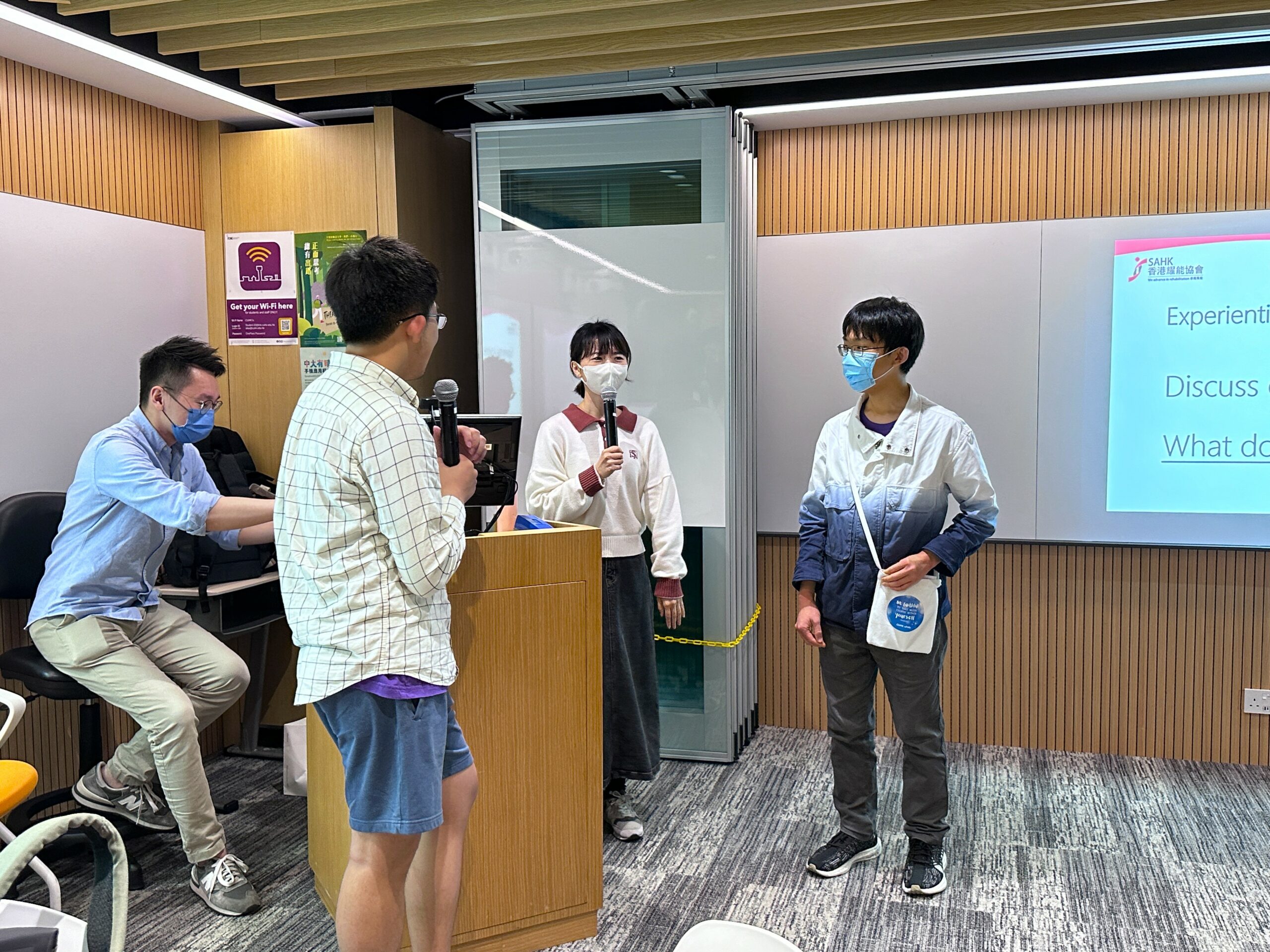 Two students participating in a role play session, talking to each other and actively engaging in the activity.